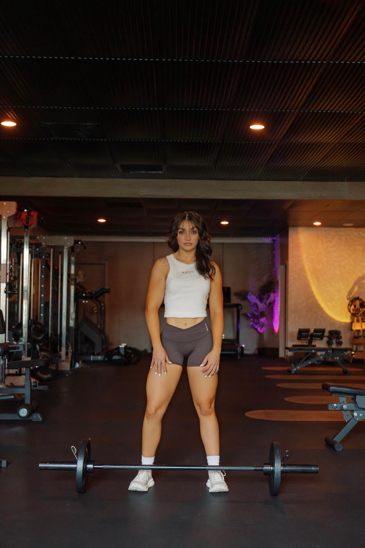 Lauren standing behind a barbell at Haven Fit.
